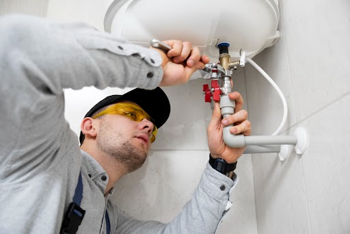 Plumber inspecting a hot water system